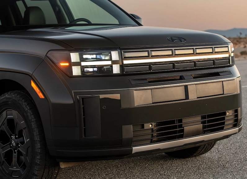 The 2026 Hyundai Santa Fe is a three-row midsize SUV featuring a turbocharged engine and distinctive boxy design elements.